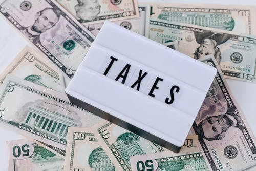 Picture with money and taxes sign Picture with money and taxes sign